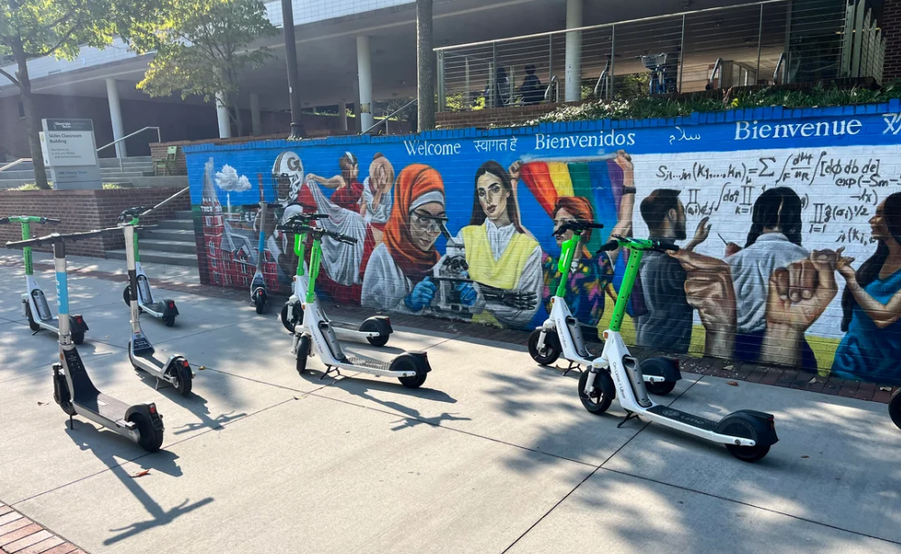 An image showing a flock of scooters scattered across the sidewalk near Skiles blocking walking paths
