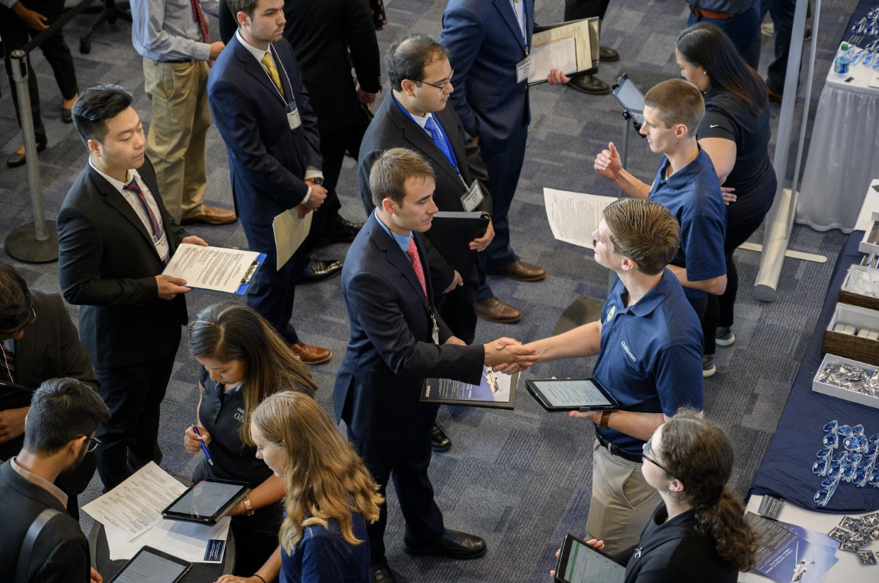Students stand in line to meet potential employers at the Georgia Tech Career Fair hosted in the basketball court of the Campus Recreation Center.