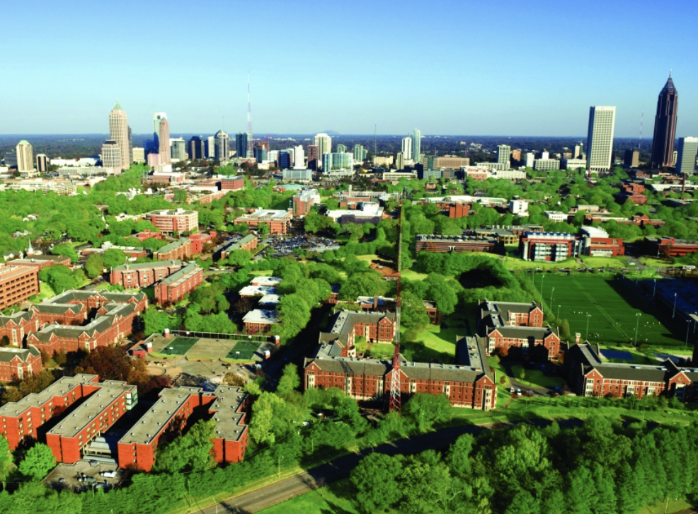 A top-down shot of a the Georgia Tech campus with the Atlanta skyline in the background