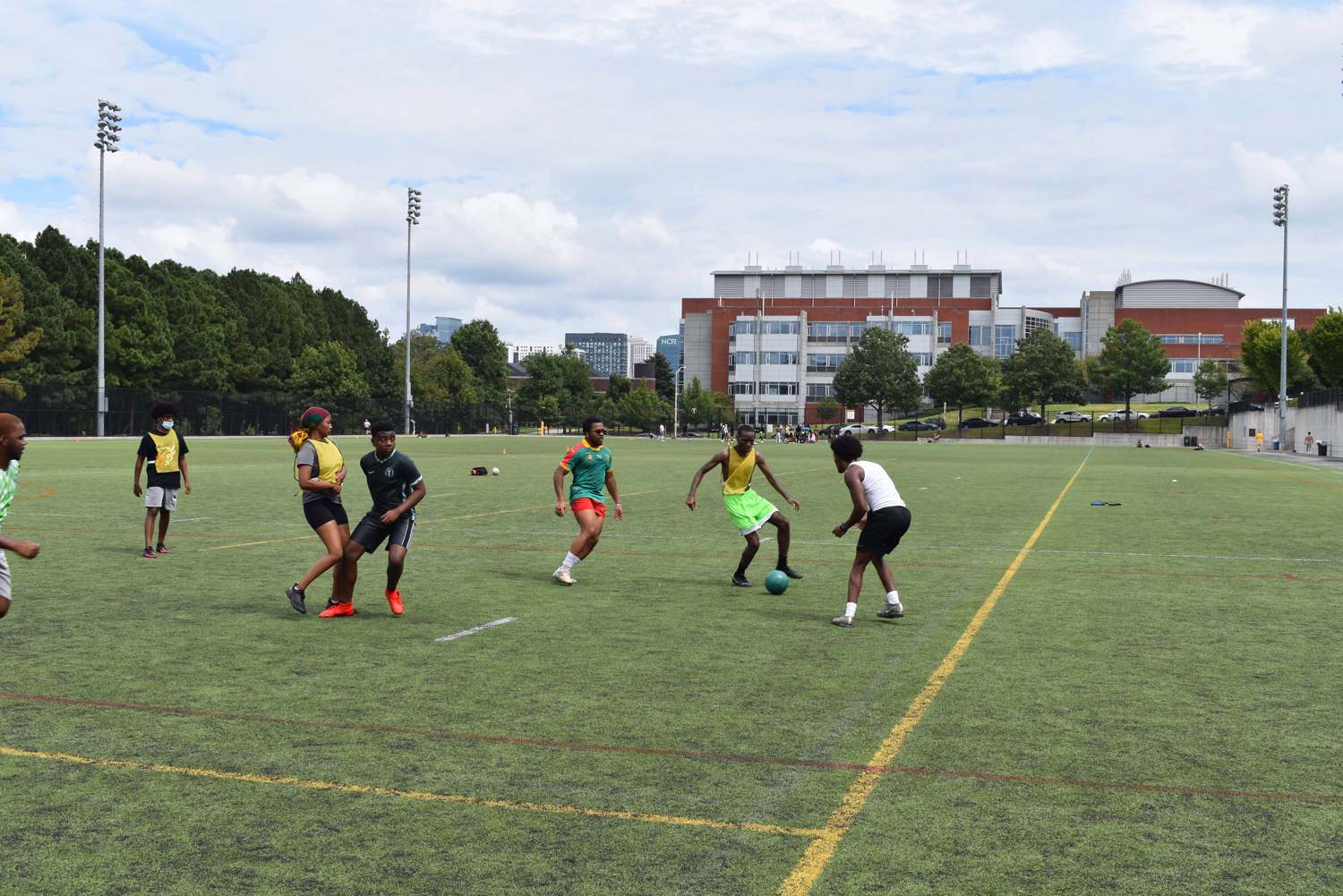 A group of African Student Association Georgia Tech students playing soccer at Roe Stamps Turf Field.