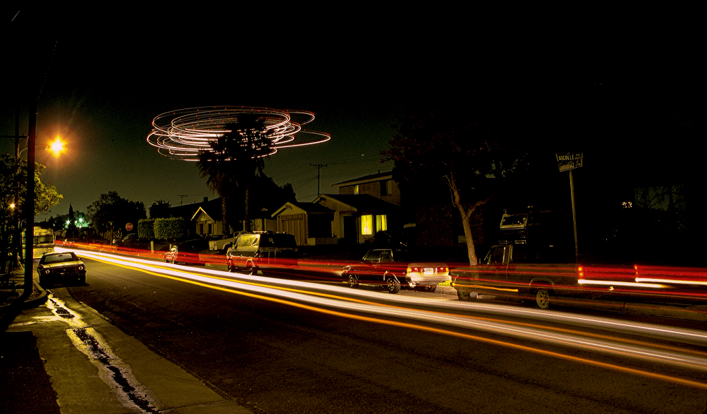 A long exposure photo, which is a technique that tracks the light moving across the entire shutter period. It shows the headlights of cars streaking across the whole image.
