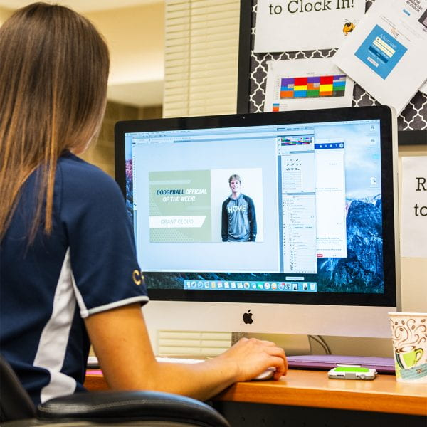 Student working at a computer in an office role at the Georgia Tech Campus Recreation Center.