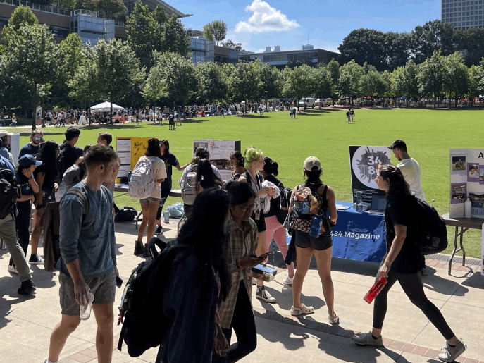 Students tabling, walking through booths, and talking to club representatives at the Georgia Tech Student Organization Fair on Tech Green.