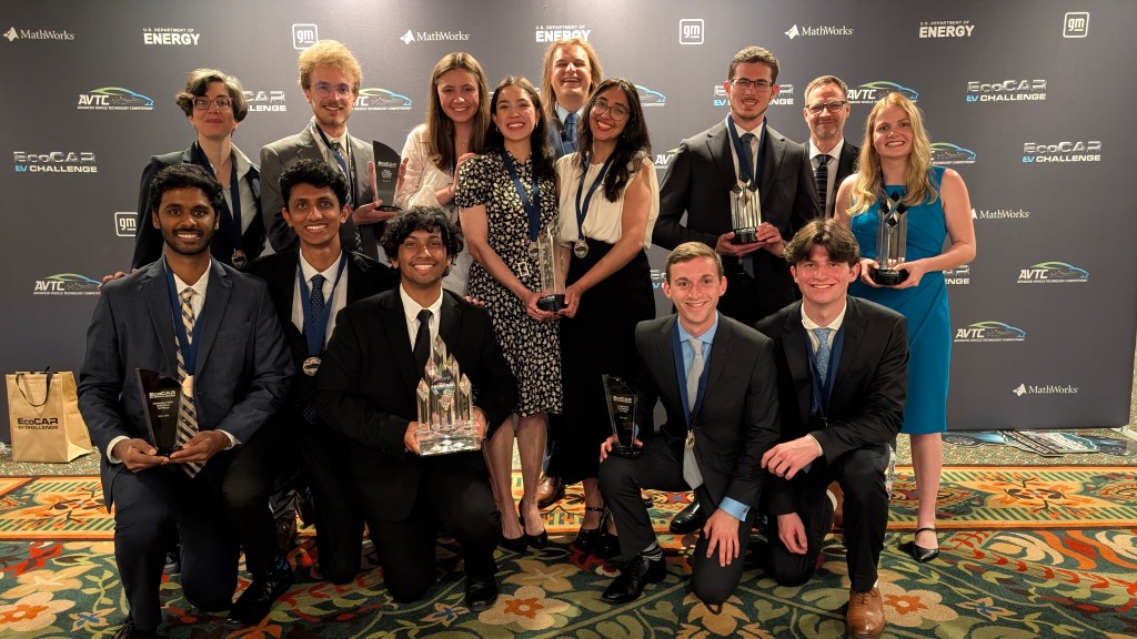 Group photo of Sebastian and the Georgia Tech EcoCAR team posing with several trophies and plaques after the Year 3 competition awards ceremony in San Diego.