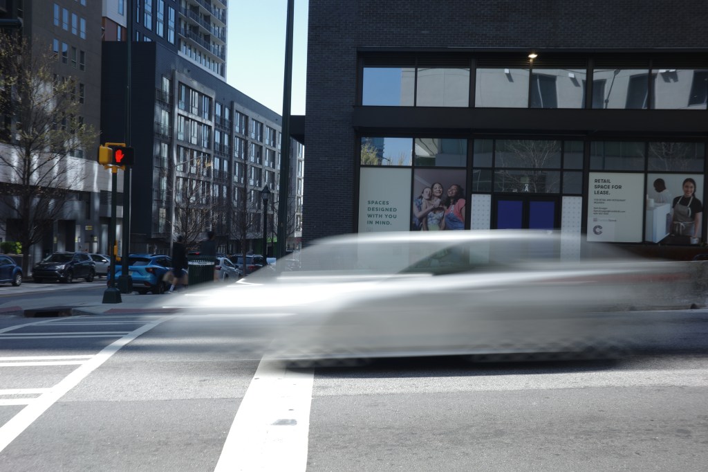 This image shows the effect of a slow shutter speed. The movement of the car is blurred.