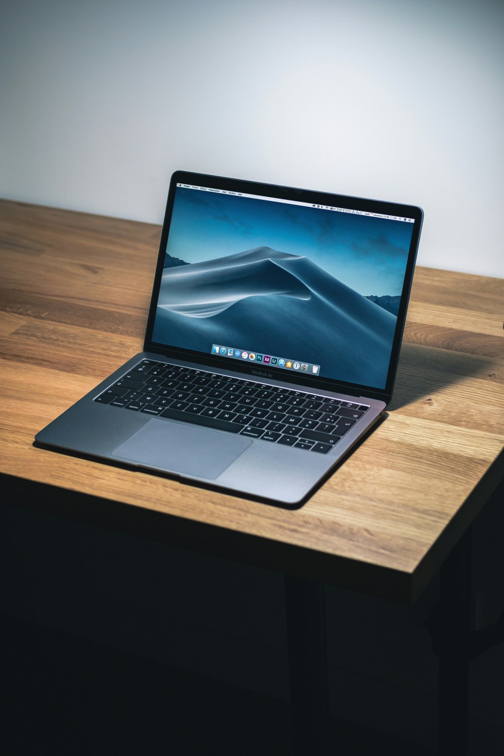 Open laptop on a wooden desk, ready for the free GT software covered in this guide.