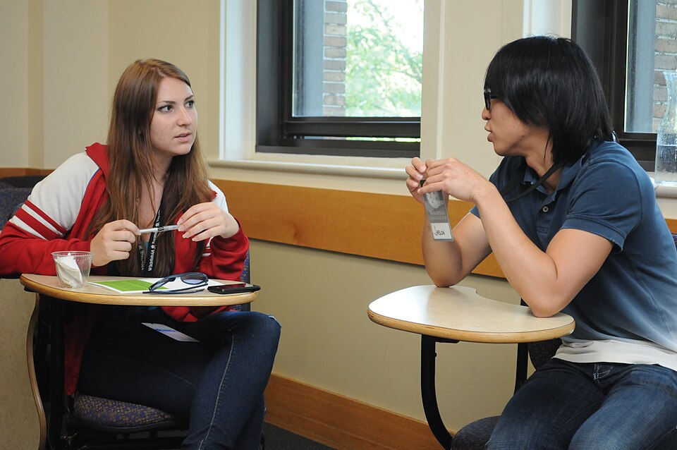 Students discussing the idea of registering for a class