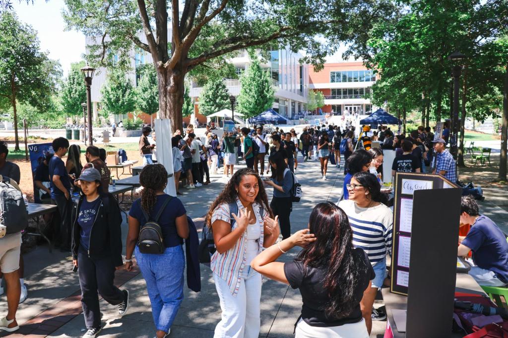 Students walking through Georgia Tech's campus near Tech Green.